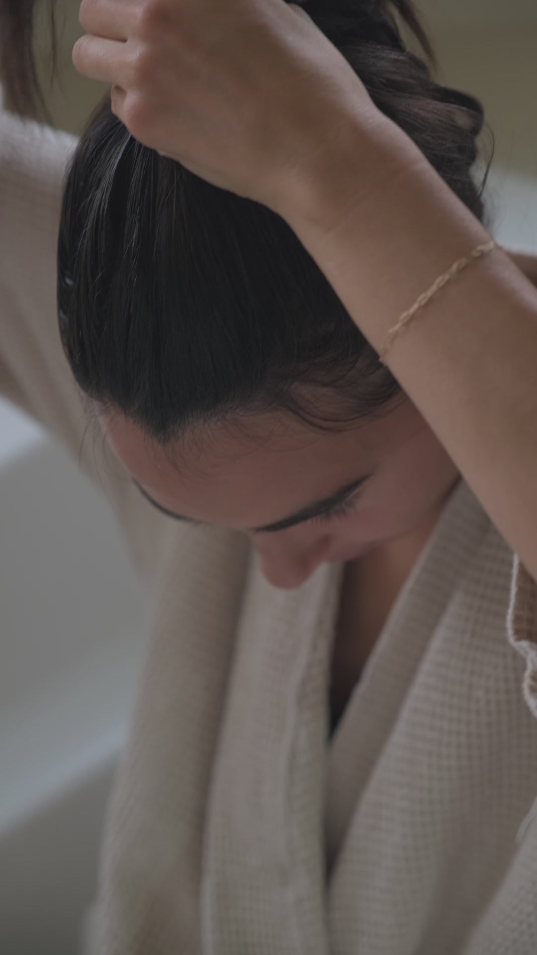 putting hair in bun and relaxing after scalp treatment